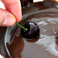 Dip the cherries in the chocolate